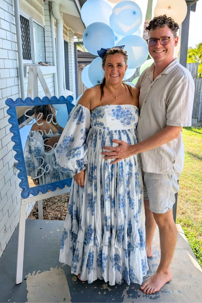 A pregnant lady wearing the Rooh Collective Poppy Flora Maxi Dress in size XL at her baby shower.