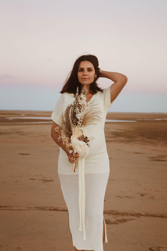 Beautiful pregnant mama wears the Hazel and Folk Melody Maxi in buttercream