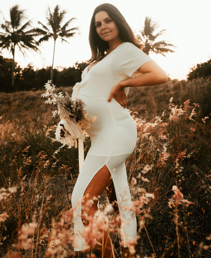 Beautiful pregnant mama wears the Hazel and Folk Melody Maxi in buttercream