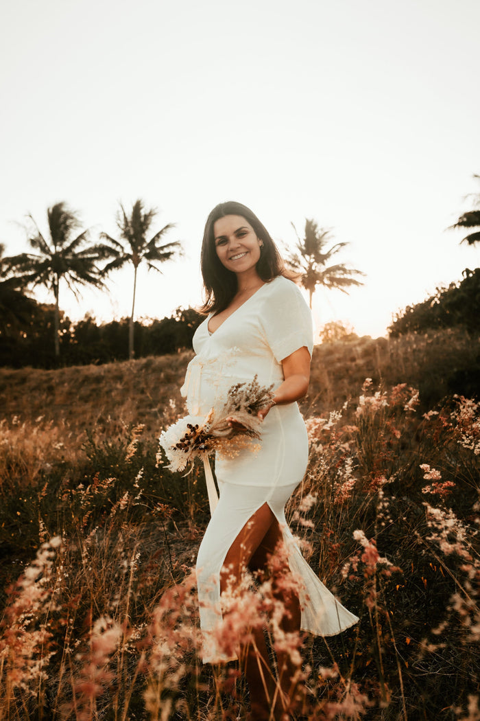 Beautiful pregnant mama wears the Hazel and Folk Melody Maxi in buttercream