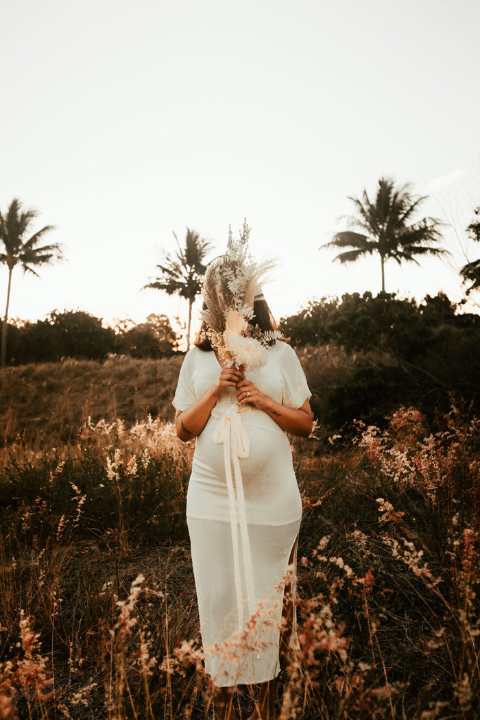Beautiful pregnant mama wears the Hazel and Folk Melody Maxi in buttercream