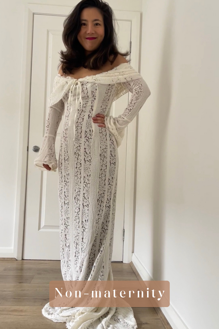 Woman wearing a lace off-shoulder dress standing in a room with a white door.